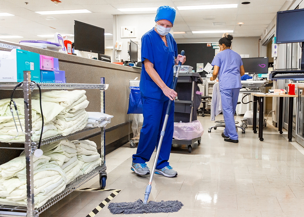 Clinical service assistant cleaning up the floor in the clinical care areas