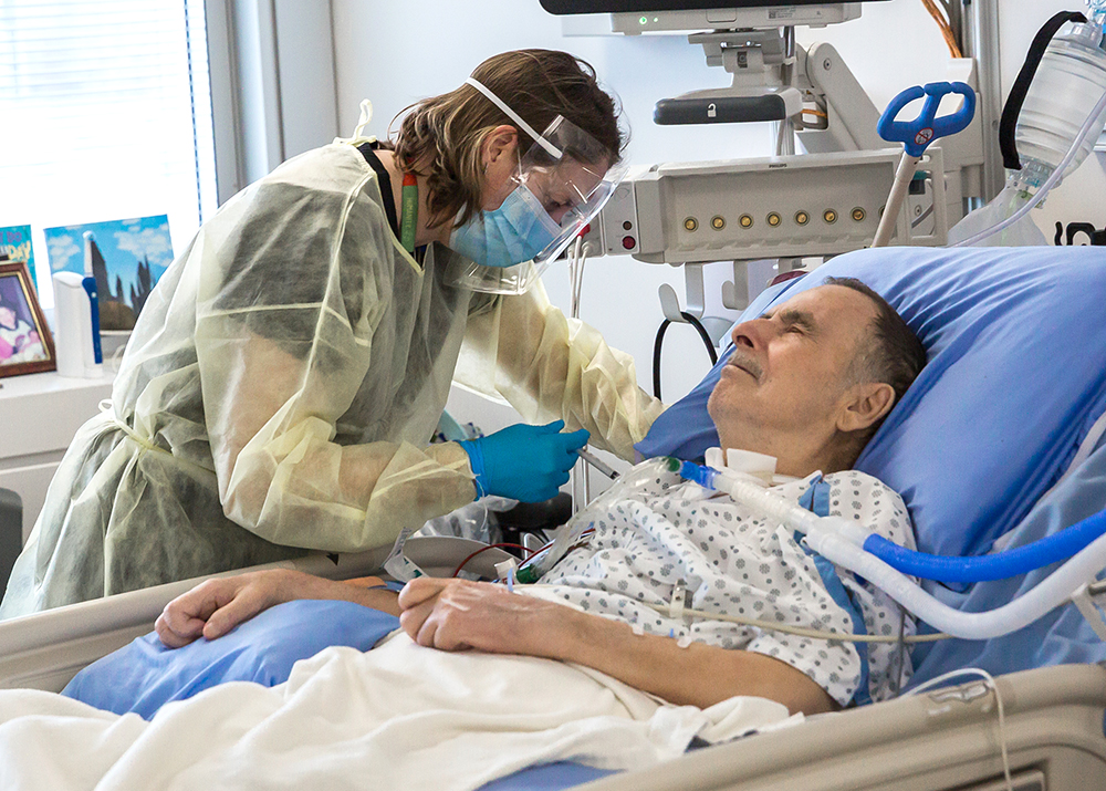 Physician administering the COVID-19 vaccine to complex care and long-stay patients at Mount Sinai