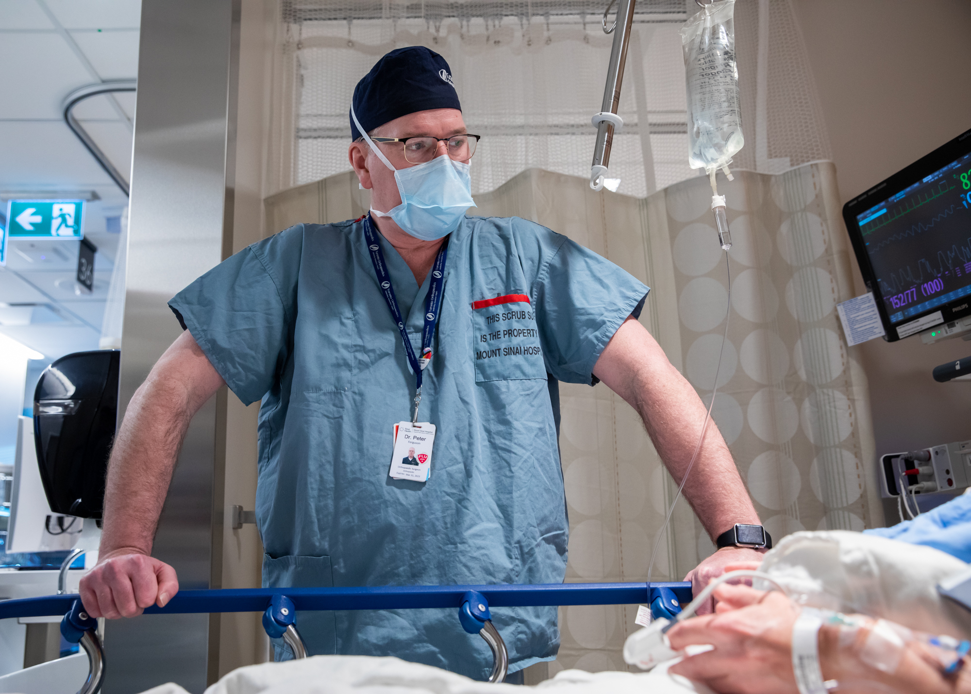 Dr. Peter Ferguson, orthopaedic surgeon, speaks with his patient prior to surgery