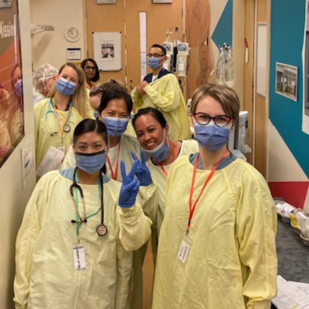 Participants in full gowns and masks