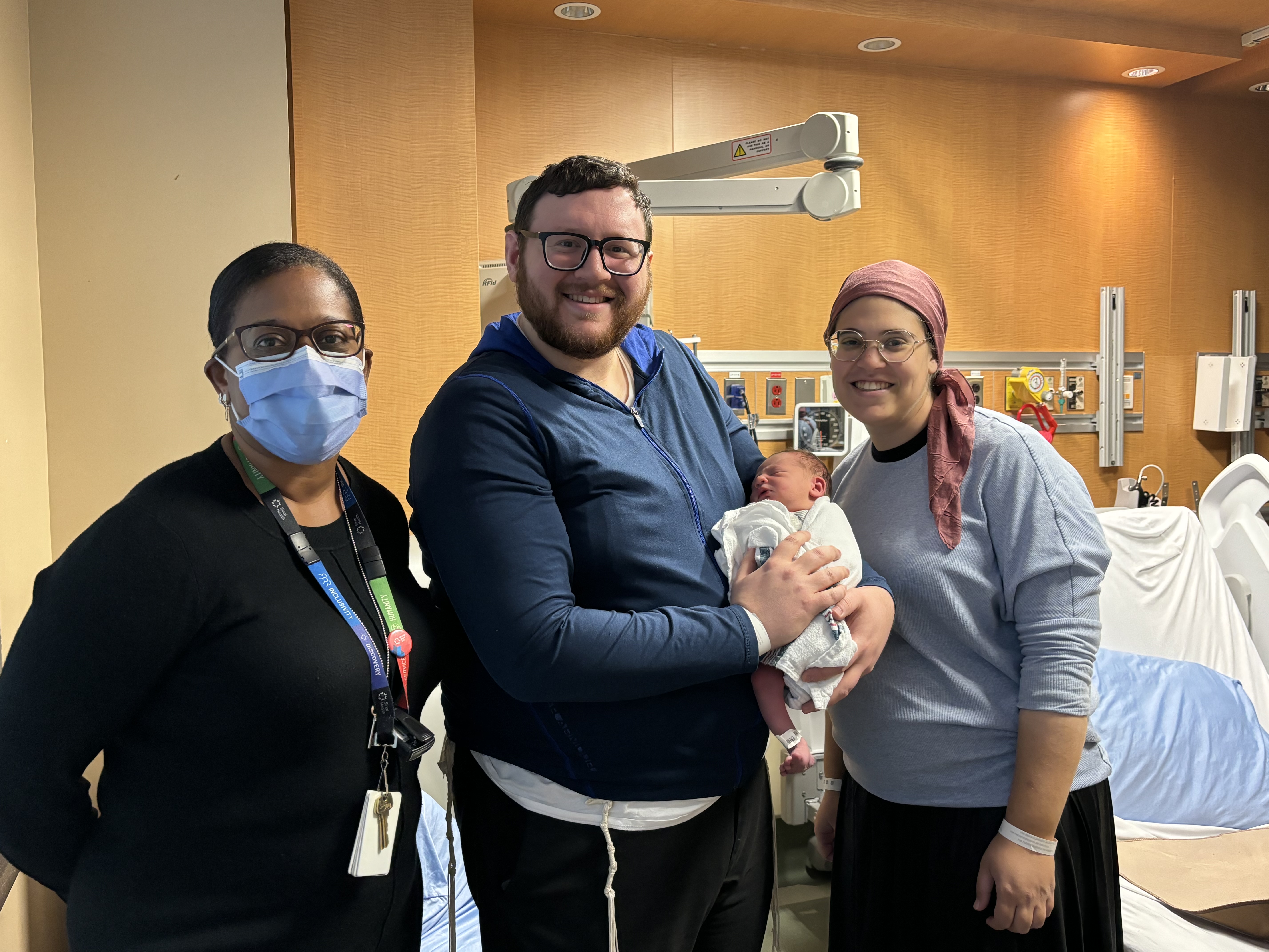 Dr. Diambomba with the parents of the baby who received the first RSV vaccine at Mount Sinai Hospital.