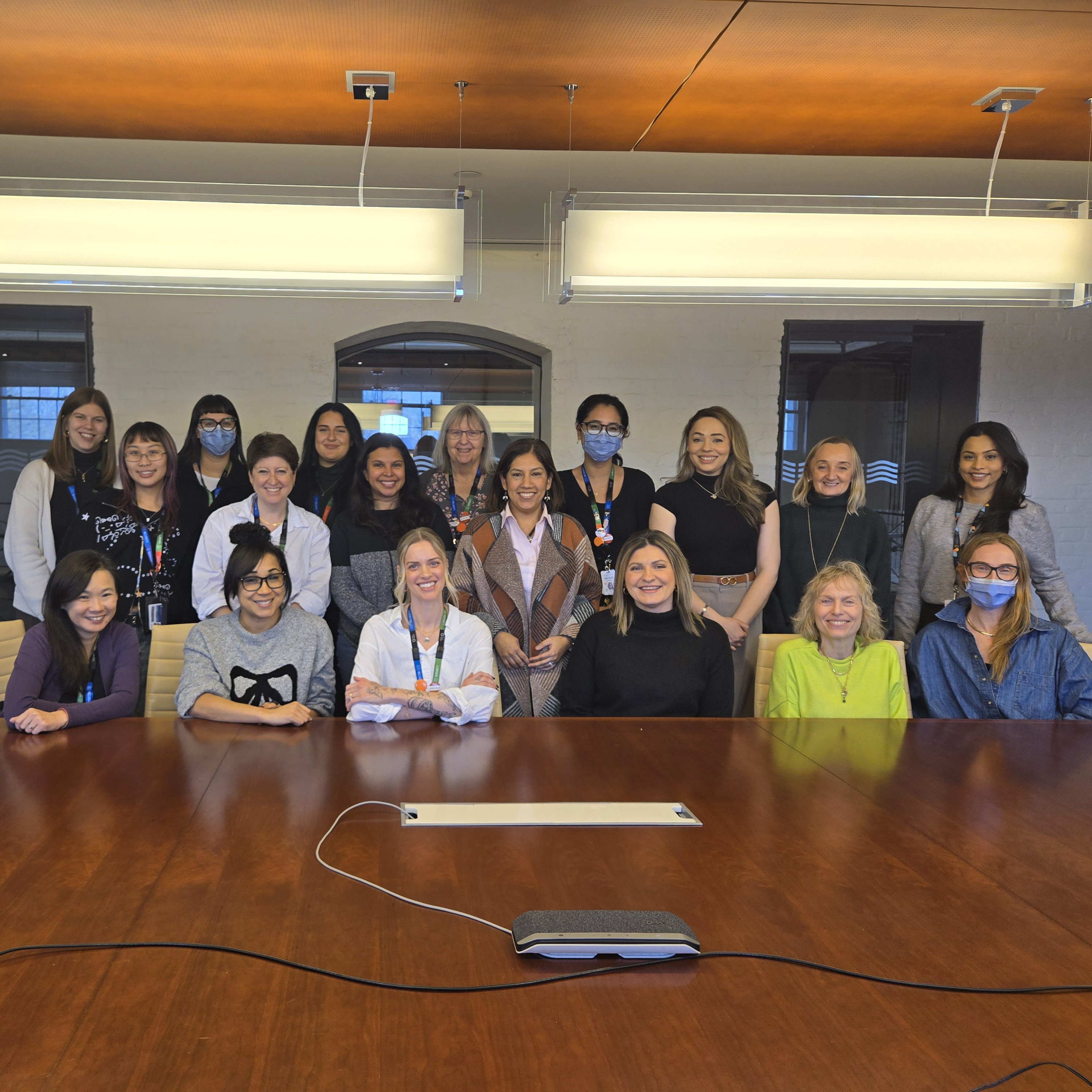 A group photo of Sinai Health to Home members at a boardroom table.