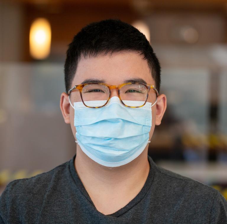 A staff member wearing a face mask