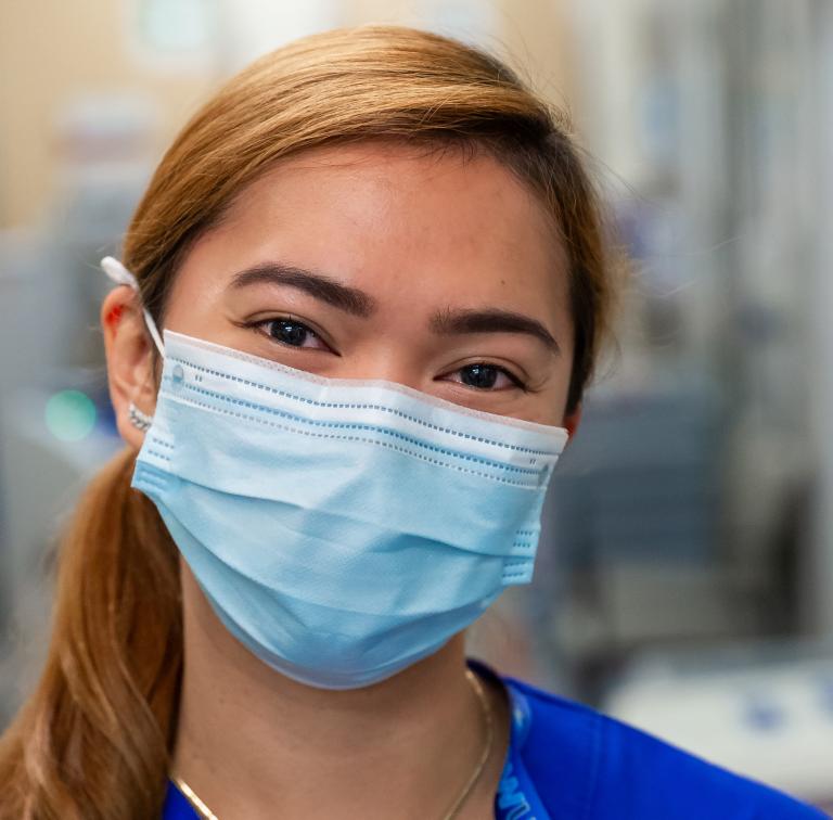 A staff member wearing a face mask