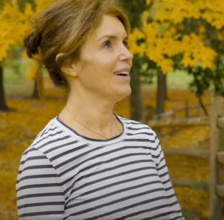 Woman wearing a striped shirt in a park in the fall