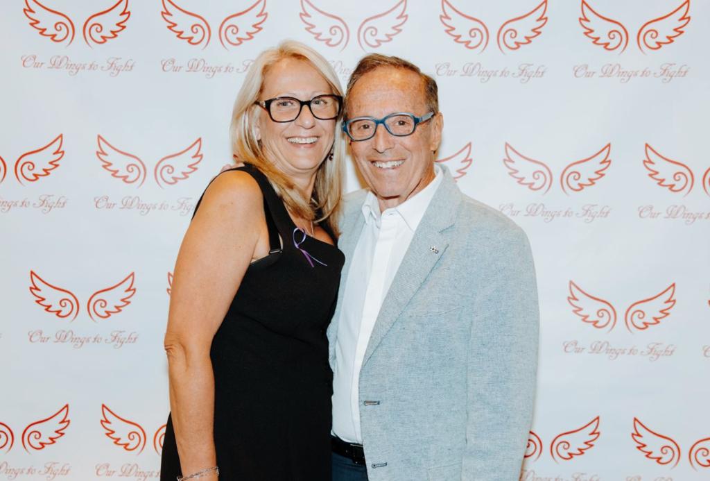 two people embracing in front of a photo backdrop