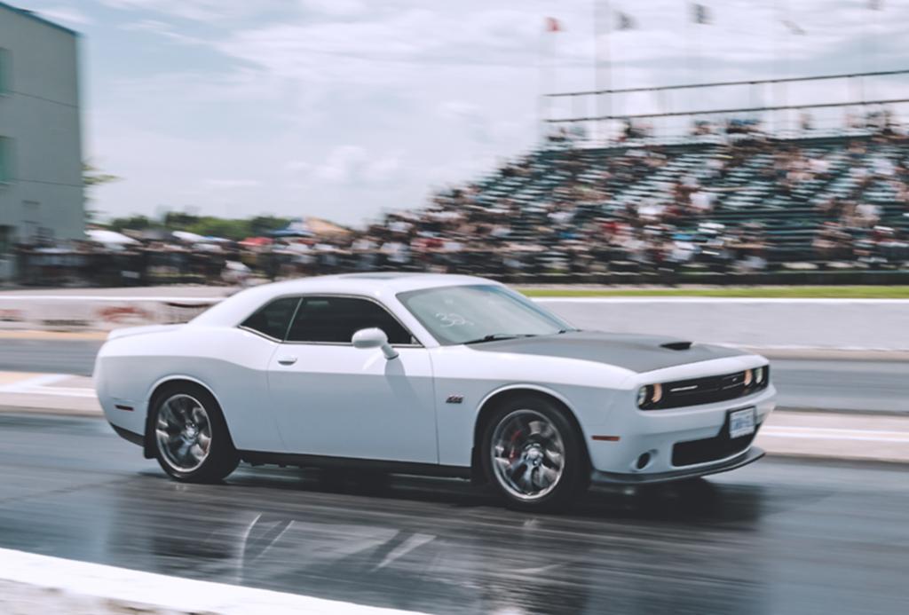 car racing on a track with an audience in stands