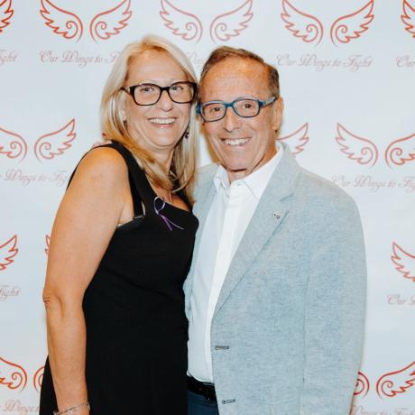 two people embracing in front of a photo backdrop