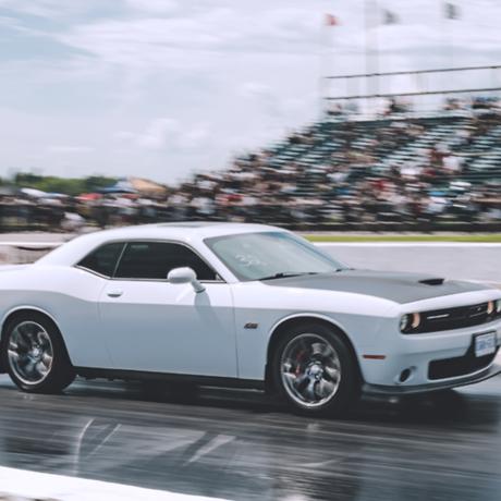 car racing on a track with an audience in stands