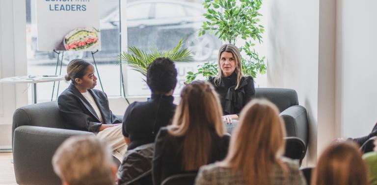 Women interviewing another women in front of an audience