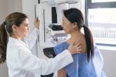 Doctor supporting a patient during mammogram test