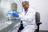 A scientist works on a sample in a laboratory