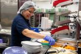 A staff member prepares food in the hospital kitchen