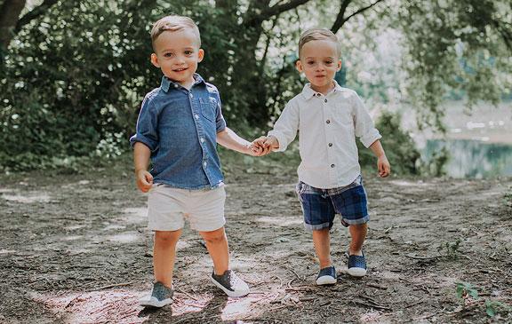 Toddler twins holding hands