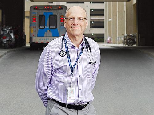 Man standing outside with an ambulance in the background