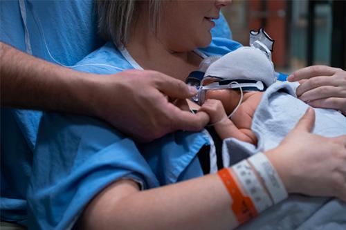 A woman holding her newborn baby