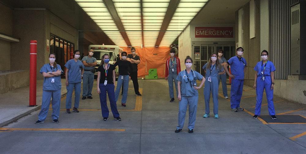 COVID-19 frontline staff stand in front of the Emergency Department