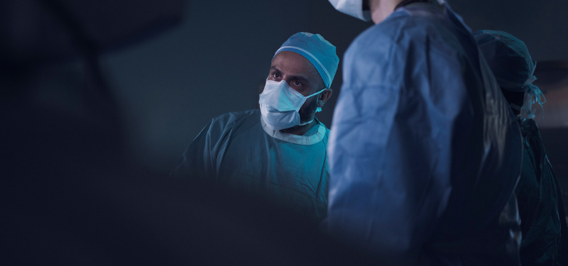 Picture of doctor in a mask looking at something