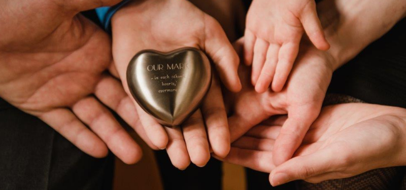 Photo of Mark’s family holding on to a precious memento provided by Lindsay Coad