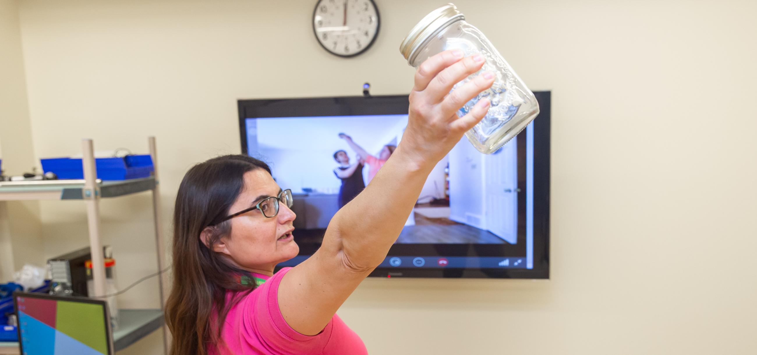 a physiotherapist taking a virtual rehab session