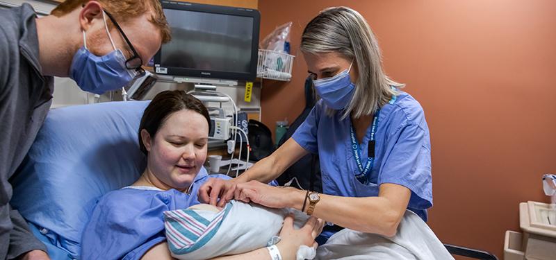 Mother and baby receiving care from a healthcare professional