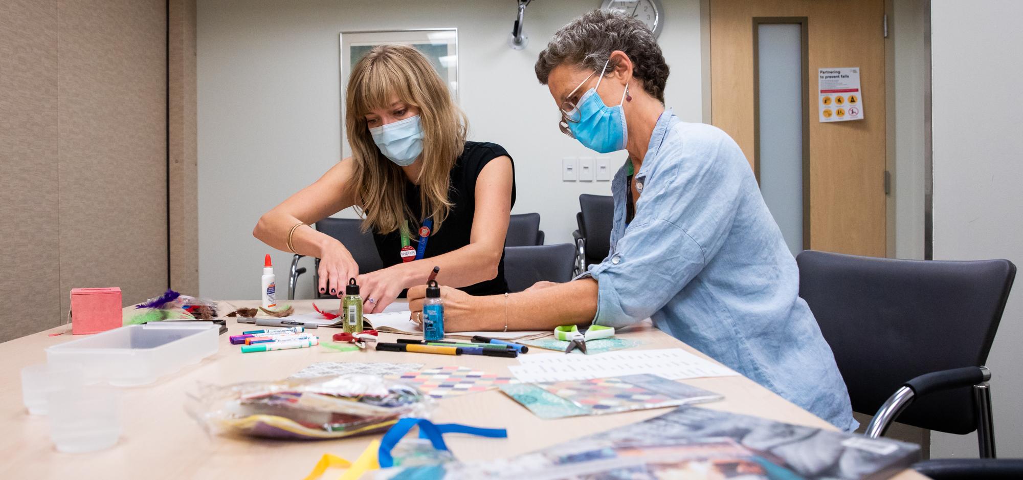 Two female Mount Sinai Hospital employees doing arts and crafts