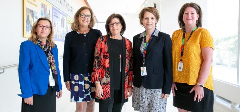 Five women standing in the Hennick Bridgepoint hallway. 