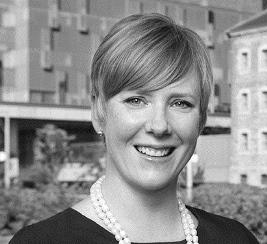 A headshot of a woman with a hospital in background