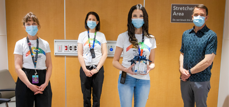 Four individuals wearing facemasks