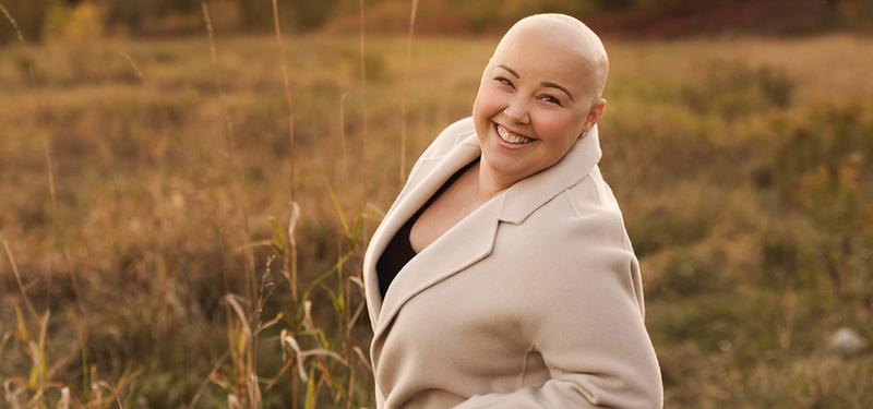 woman with no hair smiling