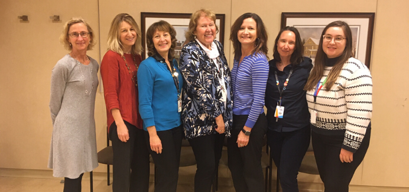 Seven women standing posing for photo at Mount Sinai Hospital.