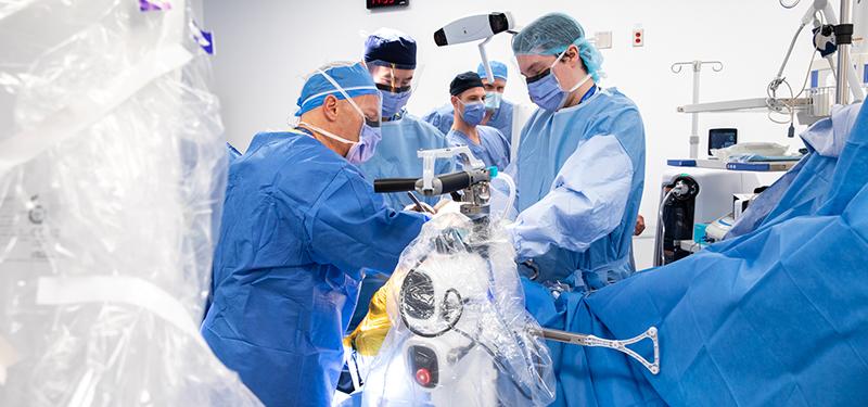 surgical team performs robotics assisted surgery