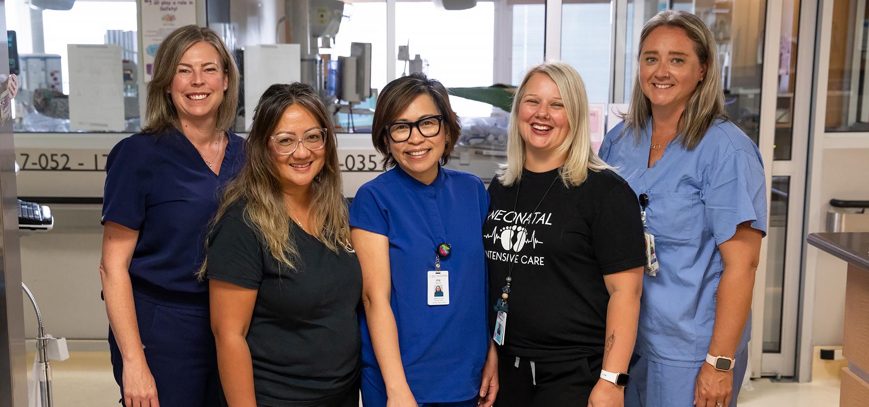 Five NICU nurses posing for group shot