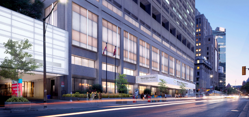 An exterior view of Mount Sinai Hospital with its windows illuminated in the evening.