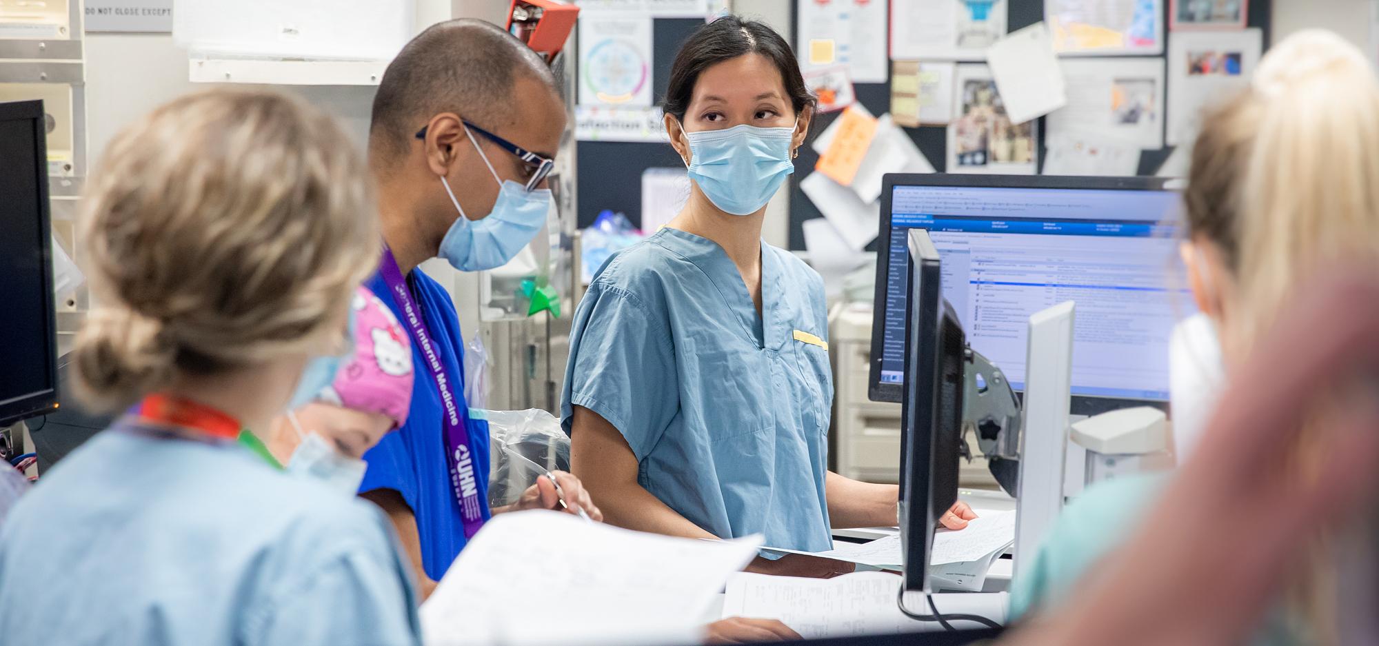 Dr. Christie Lee meets with team members in the ICU.