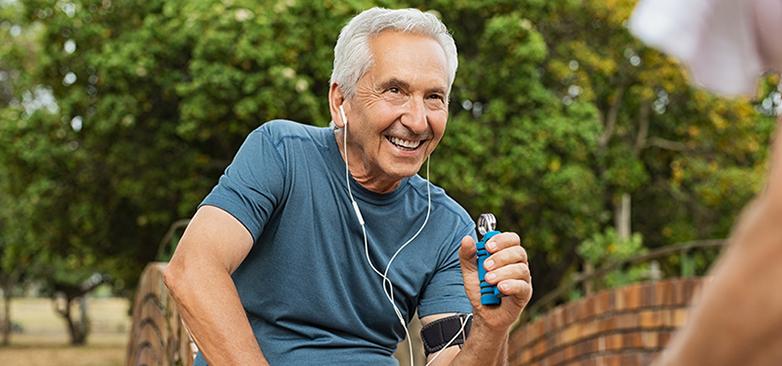 Elder man smiling using a hand-grip strengthener