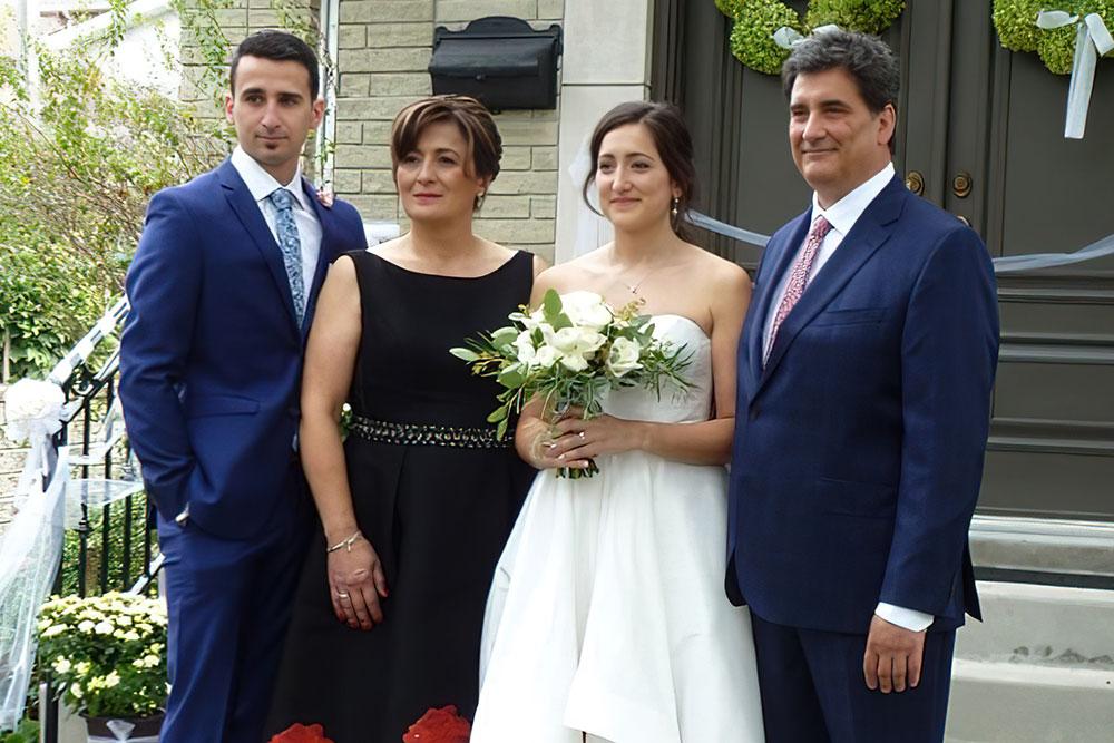 family standing with bride