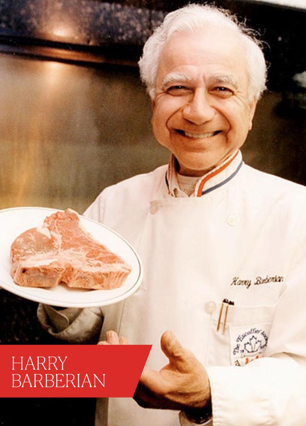 Man wearing chef jacket, holding a steak