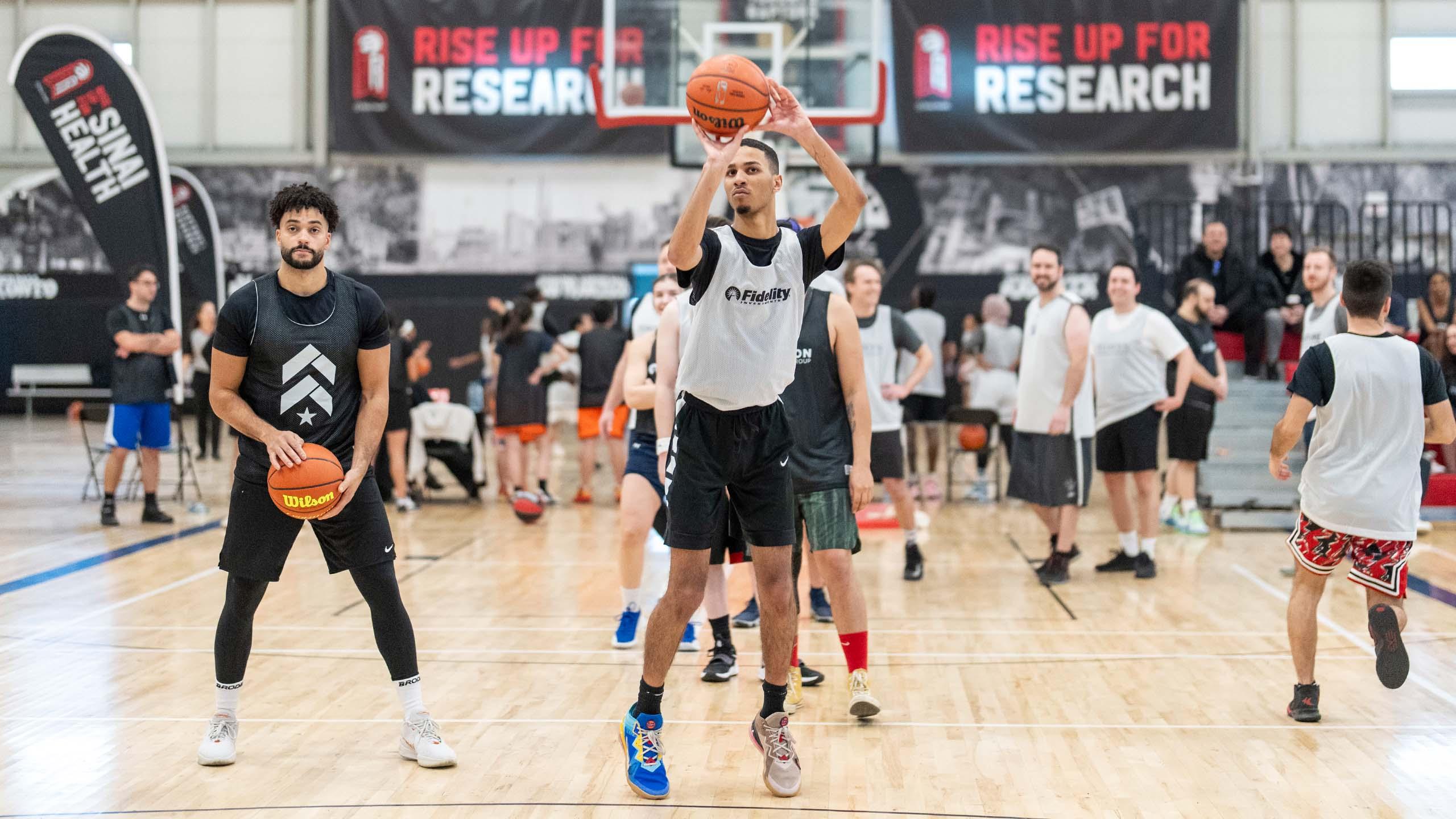 Man shooting a basketball surrounded by other players