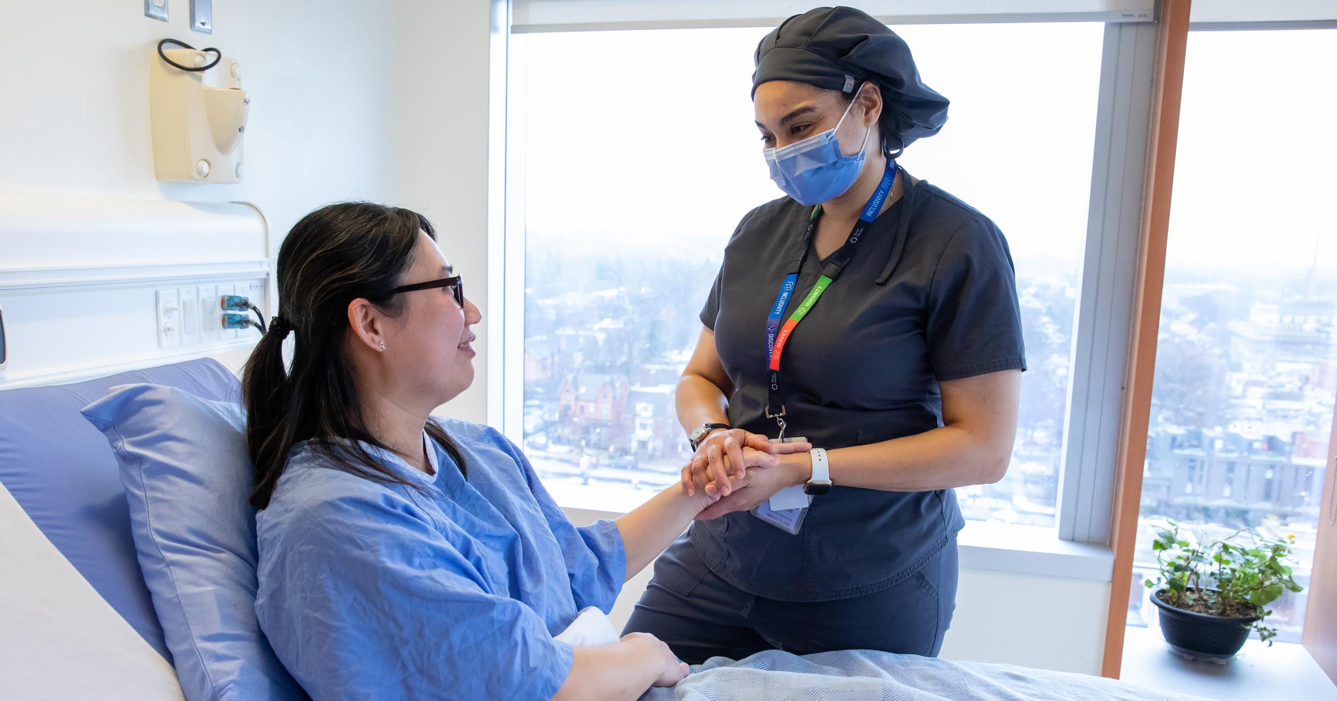 Nurse holding a patient's hand in comfort