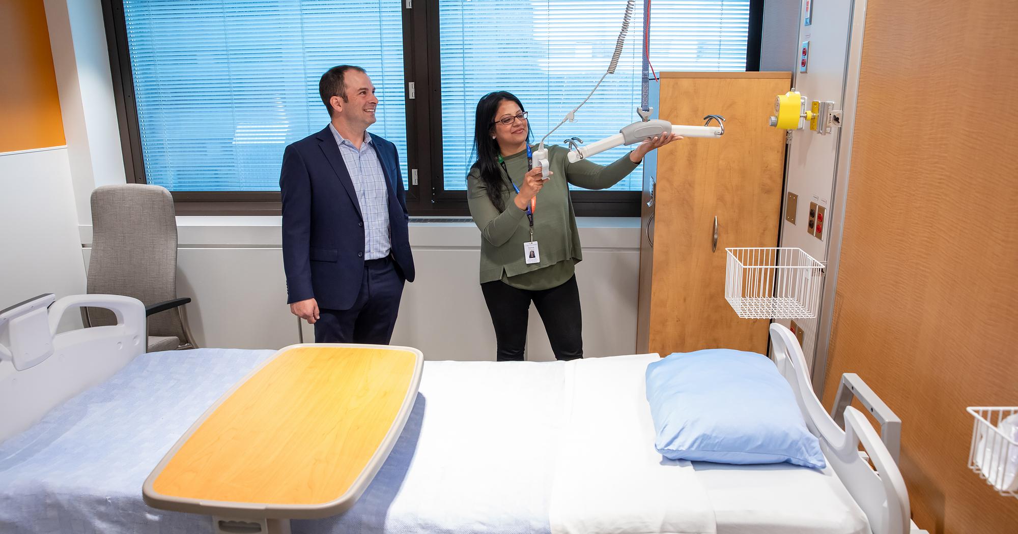 Two people in a hospital room in the general internal medicine unit. 