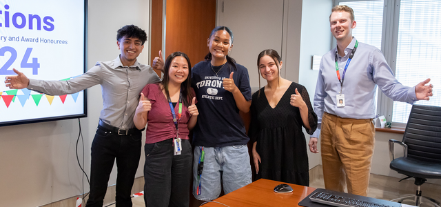 group photo of five people in a office