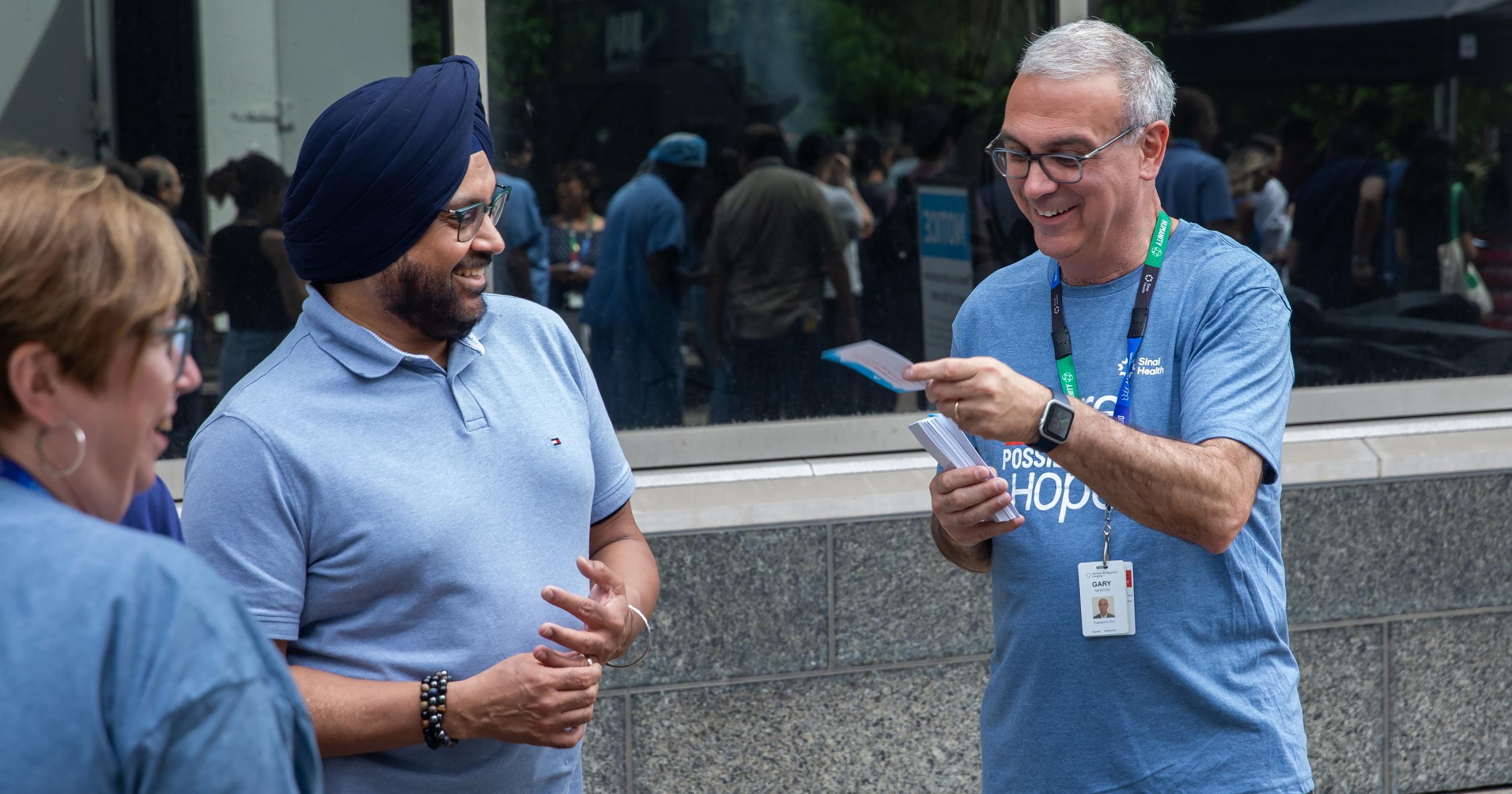 three employees smiling