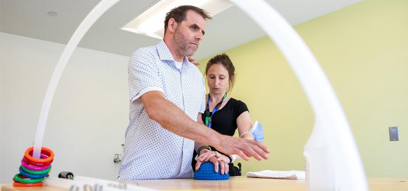 physiotherapist helping patient