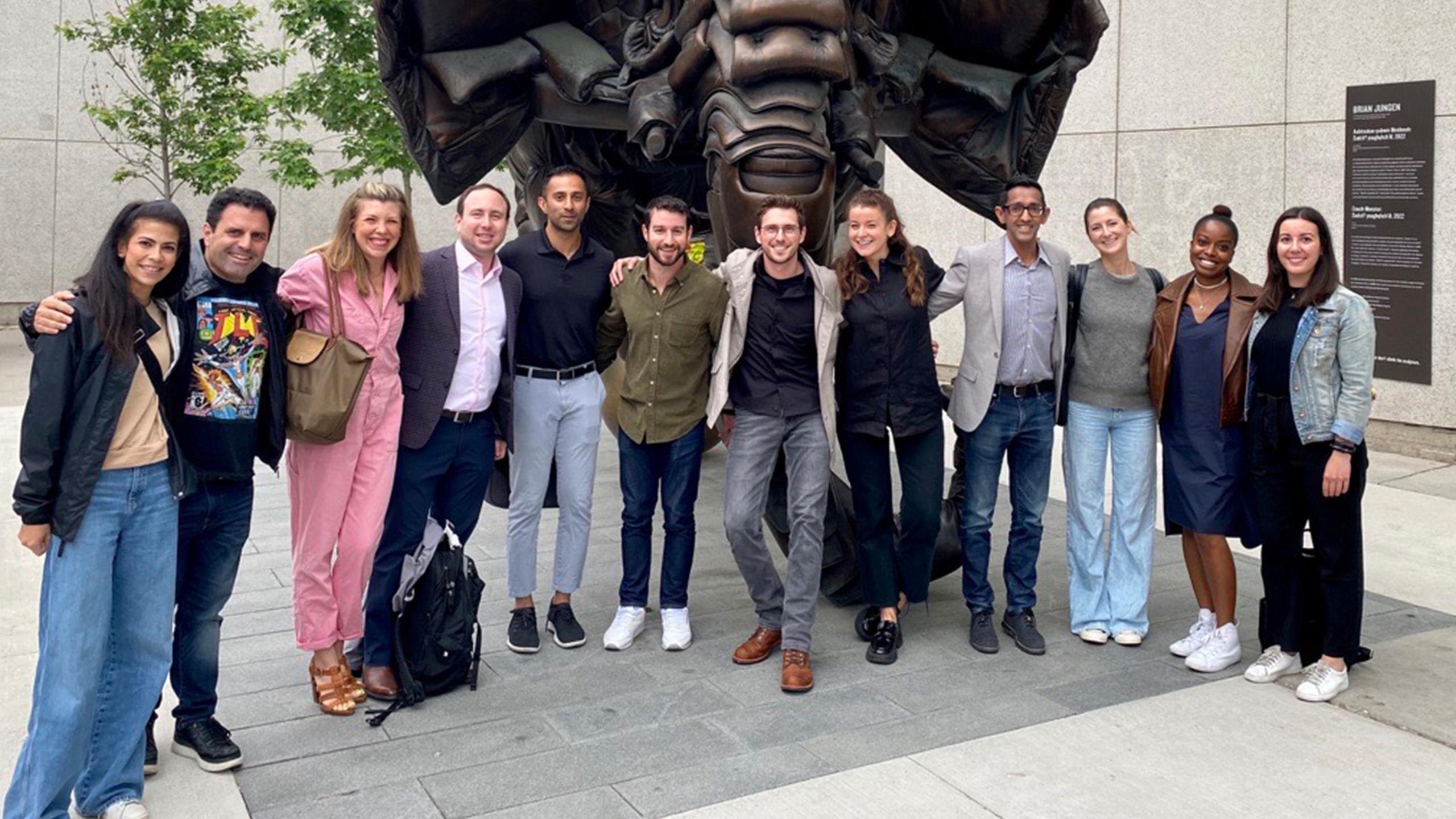 Group shot of young people in front of an elephant sculpture