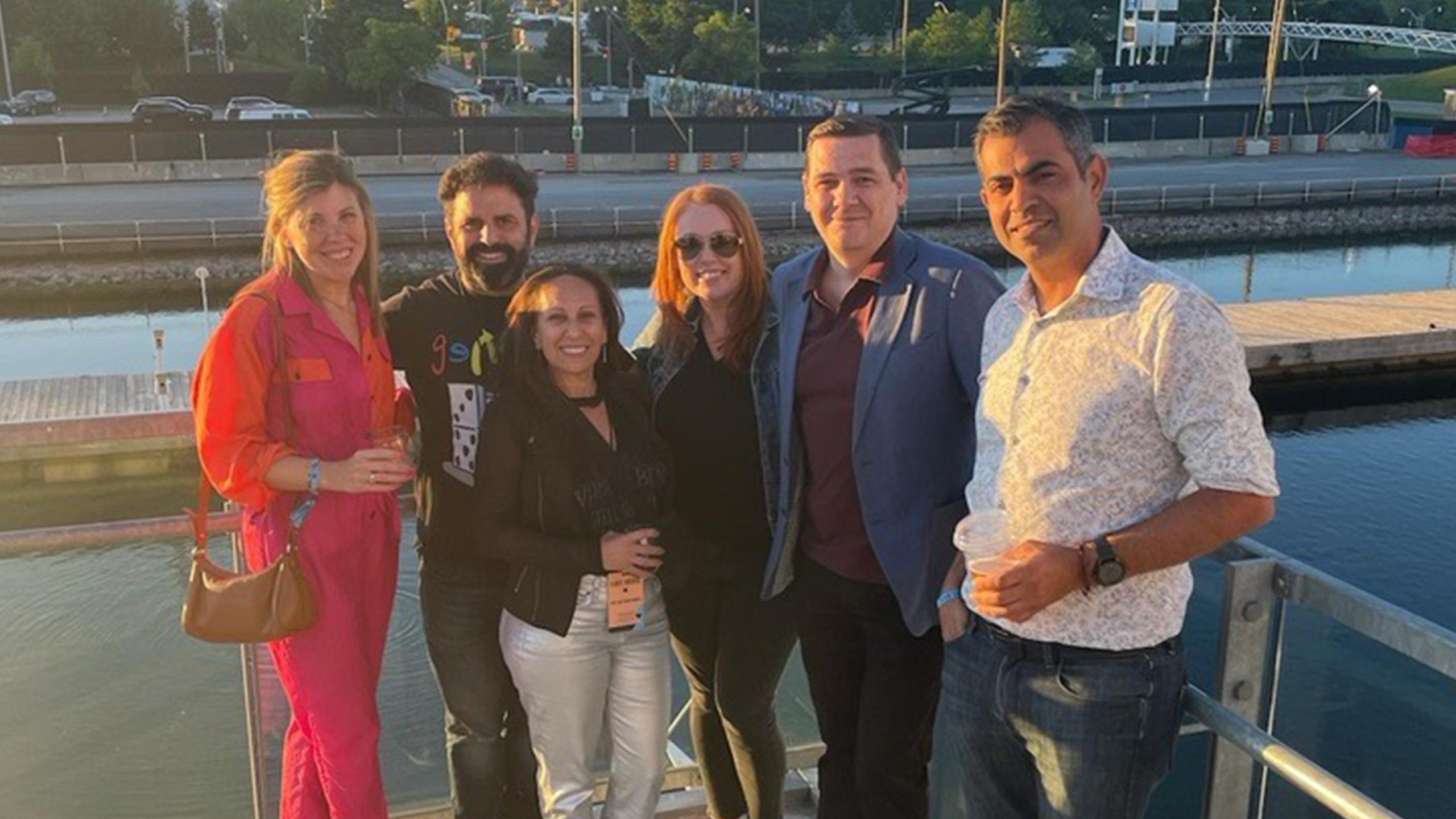 Group of people posing by the waterfront