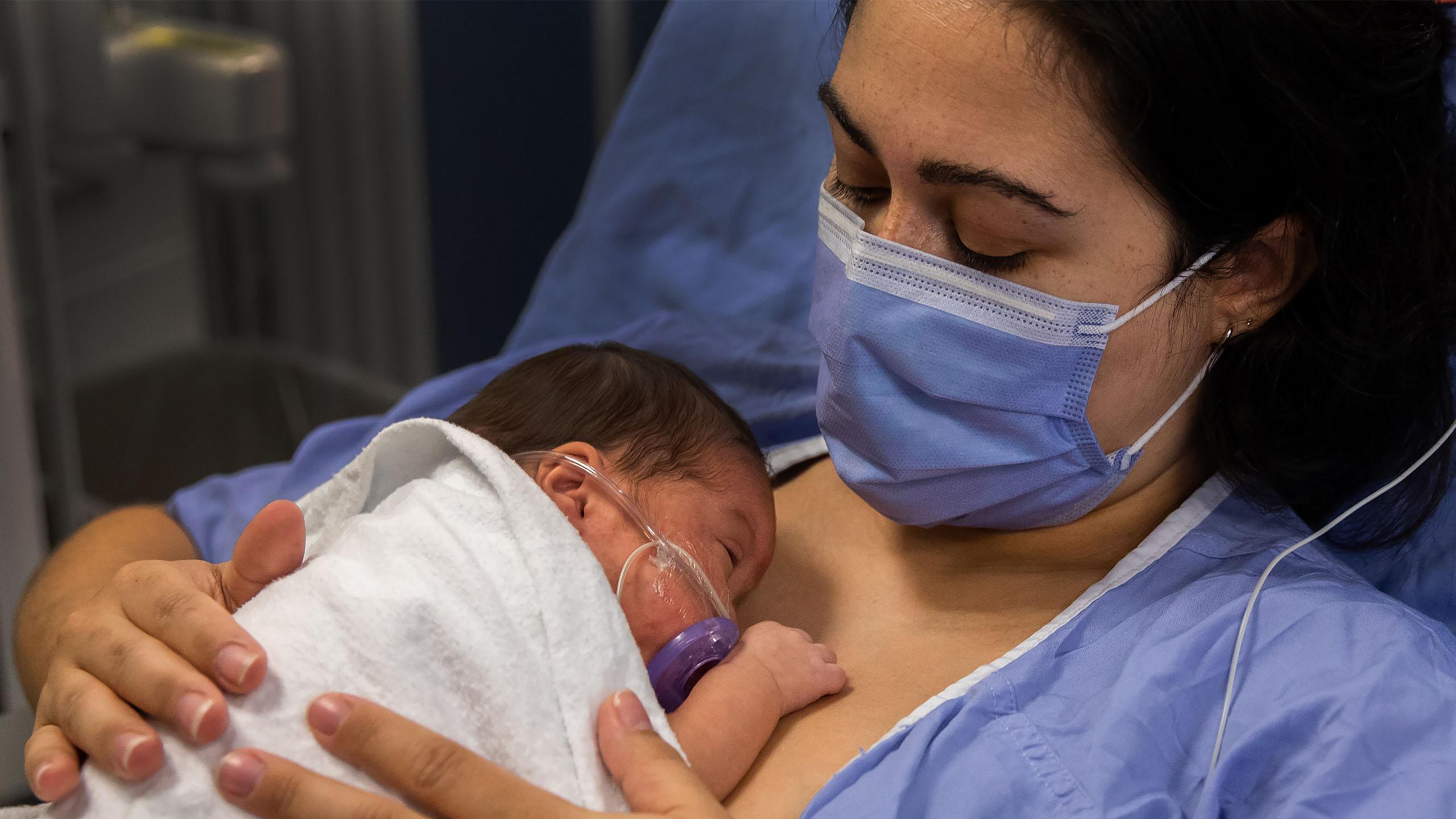 Mother with infant laying on her chest