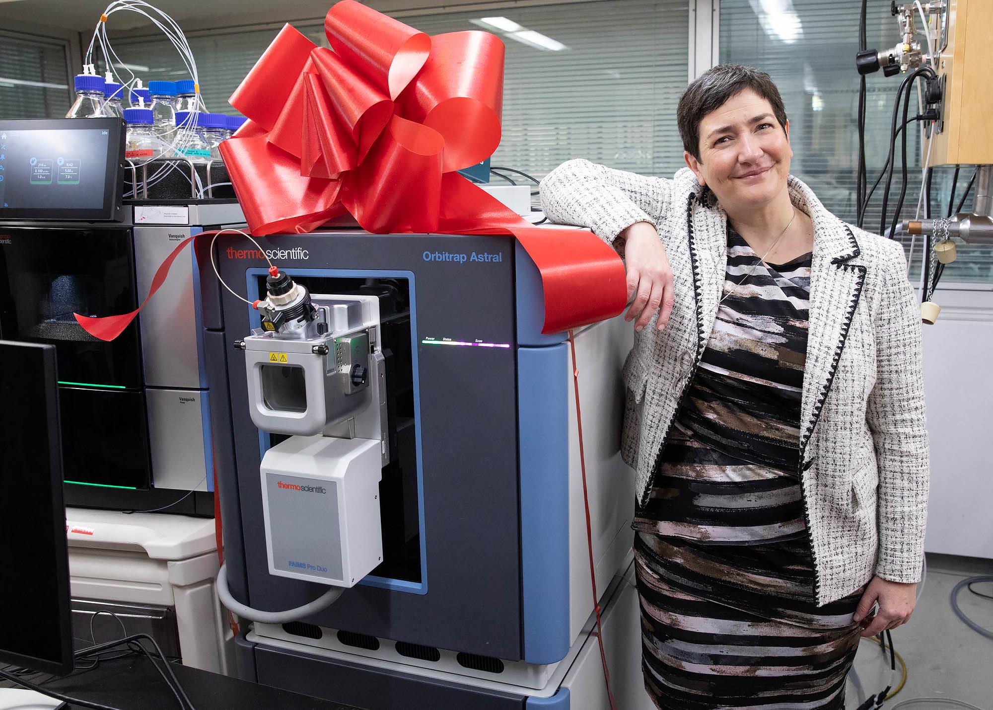 Dr. Anne-Claude Gingras stands next to the Astral mass-spectrometer