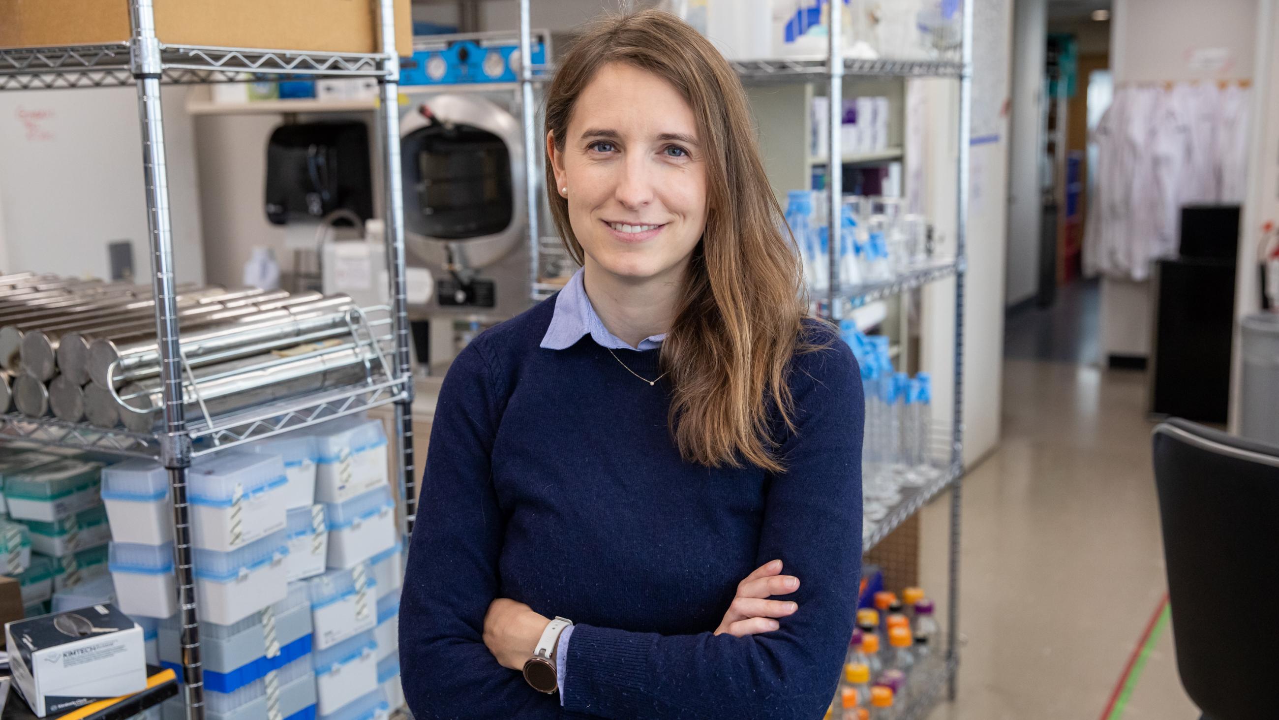 A photo of Diane Haakonsen posing inside of a lab 