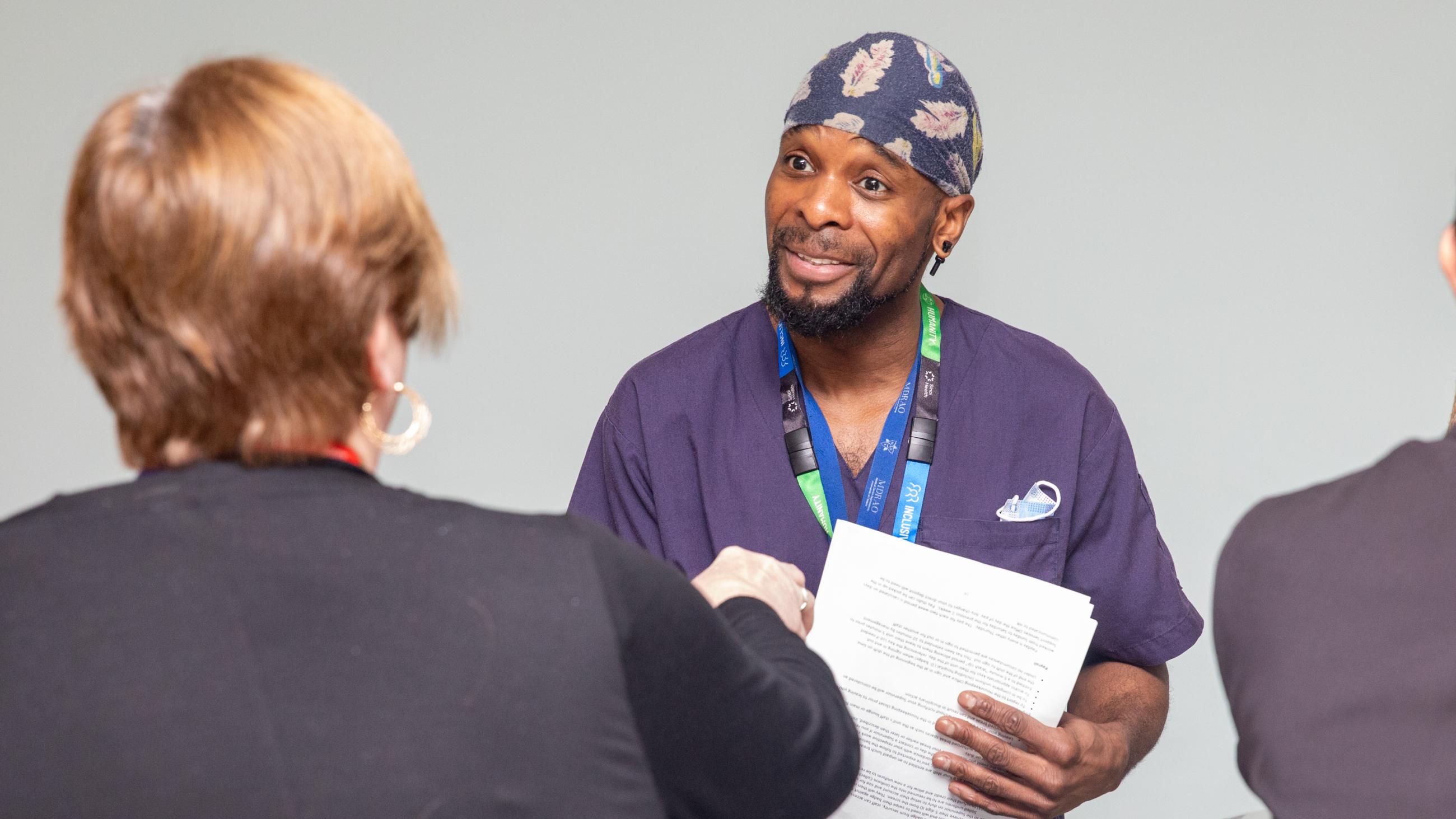 A staff member receives a holiday treat at Sinai Health’s Holiday Open House.